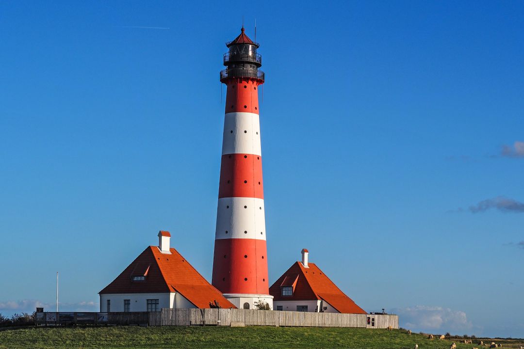 Scenic Red and White Lighthouse on a Sunny Day - Free Images, Stock Photos and Pictures on Pikwizard.com