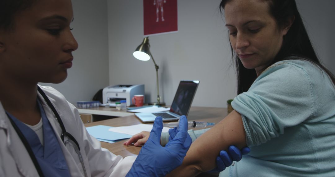 Doctor Administering Vaccine to Female Patient in Medical Office - Free Images, Stock Photos and Pictures on Pikwizard.com