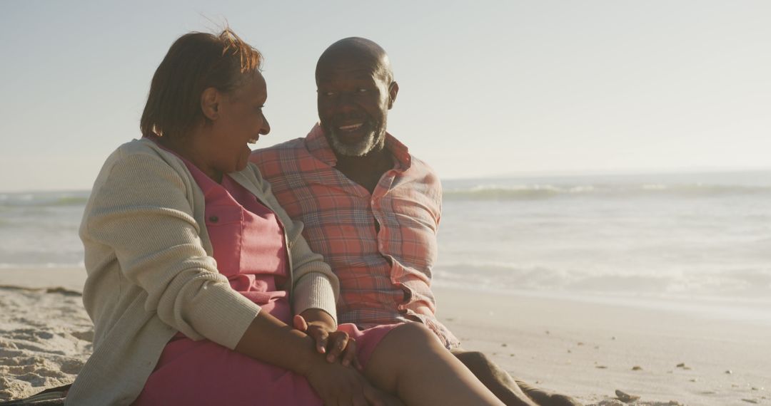 Senior African American Couple Relaxing on Beach During Sunset - Free Images, Stock Photos and Pictures on Pikwizard.com