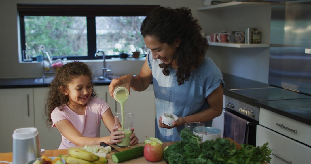 Mother and Daughter Preparing Green Smoothie in Modern Kitchen - Free Images, Stock Photos and Pictures on Pikwizard.com