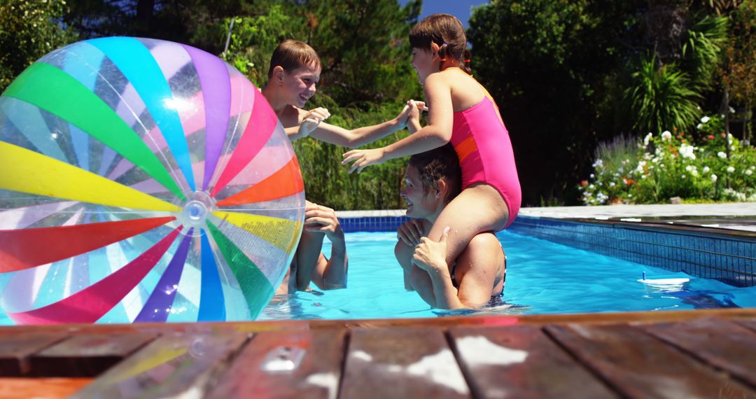 Family Playing in Swimming Pool with Inflatable Beach Ball - Free Images, Stock Photos and Pictures on Pikwizard.com