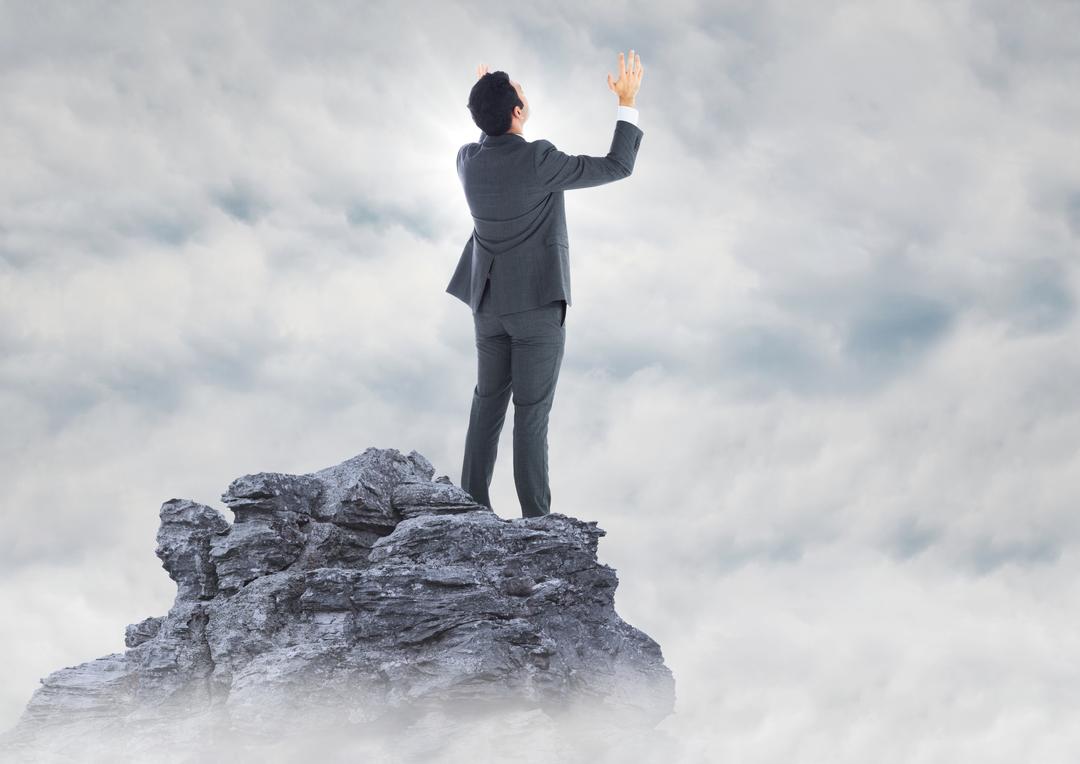 Businessman Triumphant On Mountain Peak Surrounded By Clouds - Free Images, Stock Photos and Pictures on Pikwizard.com