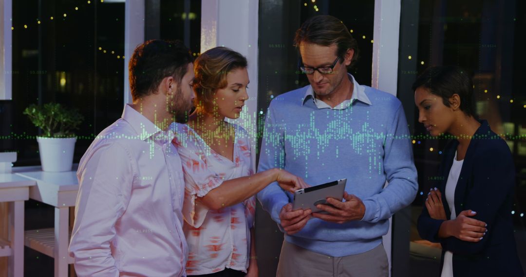 Diverse Business Team Analyzing Data on Tablet in Office