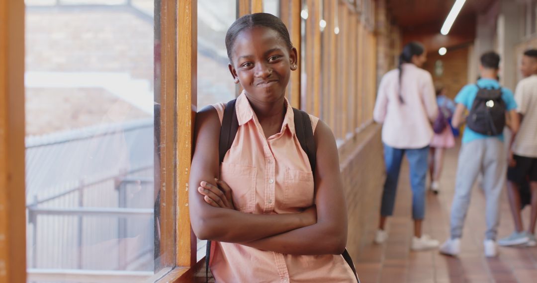 Confident Student with Backpack Smiling in School Hallway
