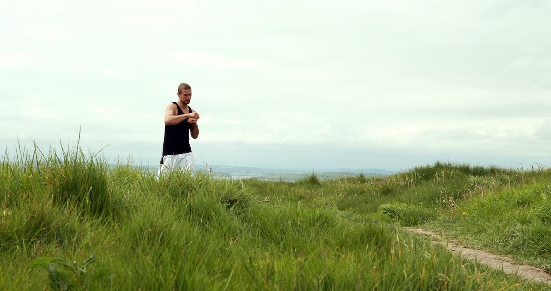 Man Jogging on a Lush Green Trail Landscape - Free Images, Stock Photos and Pictures on Pikwizard.com