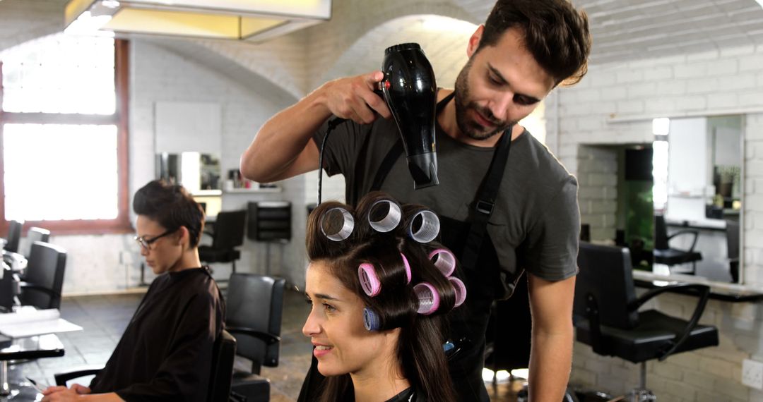 Hairdresser Styling Woman's Hair with Curlers in Salon - Free Images, Stock Photos and Pictures on Pikwizard.com