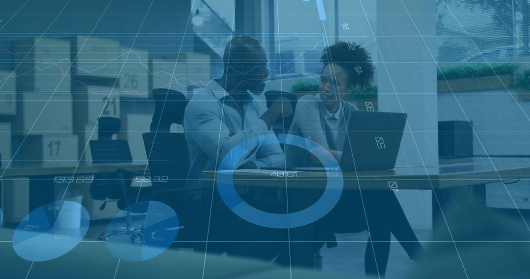 Professionals collaborating over laptop with analytics overlay in modern office