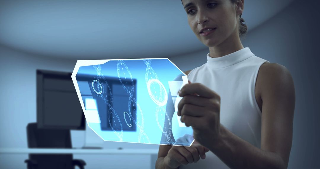 Woman Interacting with Futuristic Holographic Display in Modern Workspace - Free Images, Stock Photos and Pictures on Pikwizard.com