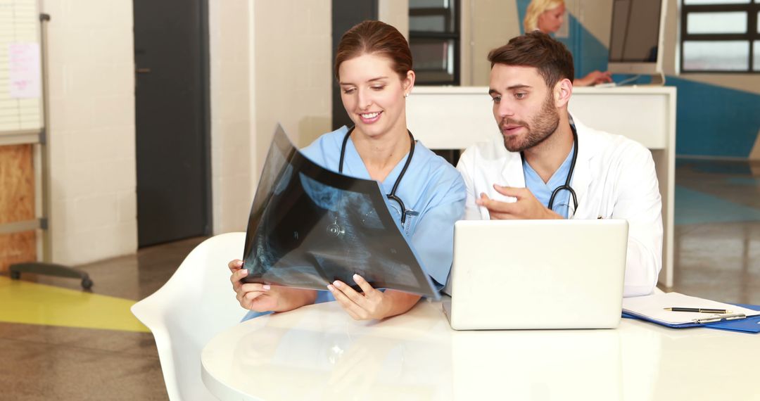 Medical Professionals Analyzing X-ray Image Together in Hospital - Free Images, Stock Photos and Pictures on Pikwizard.com