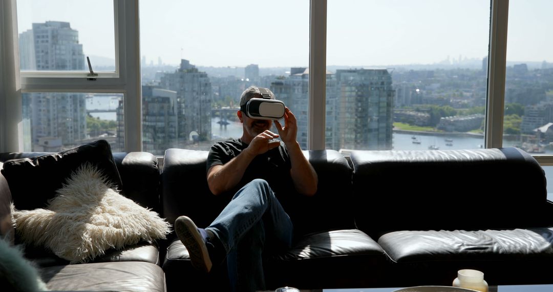 Man using virtual reality headset in modern city apartment - Free Images, Stock Photos and Pictures on Pikwizard.com