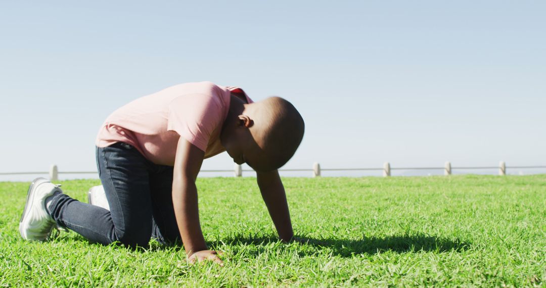 Young Boy Playing Outdoors on Grass - Free Images, Stock Photos and Pictures on Pikwizard.com