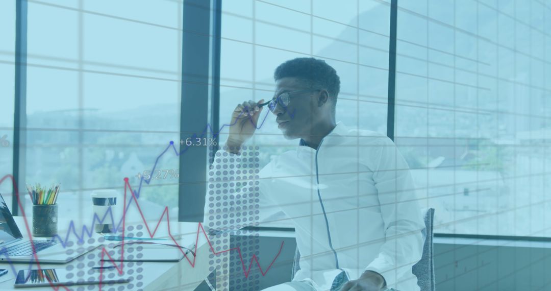 Introspective Businessman Analyzing Financial Data in Office