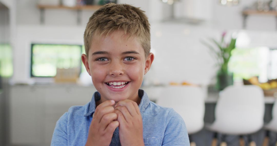 Smiling Young Boy in Bright Kitchen Dining Area