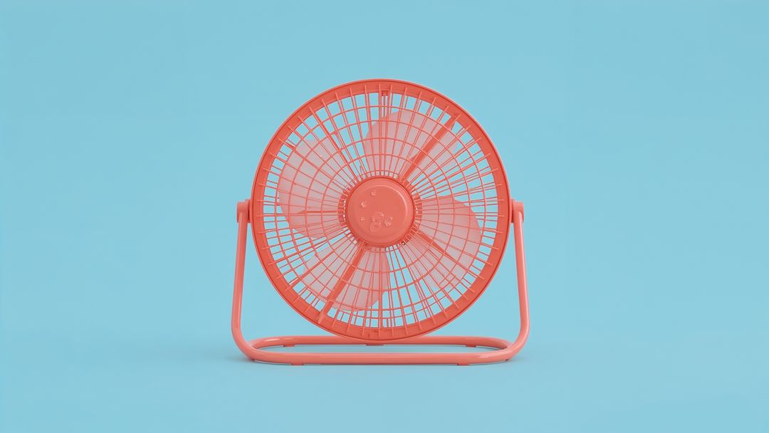 Red Desk Fan on Blue Backdrop in Studio Setting