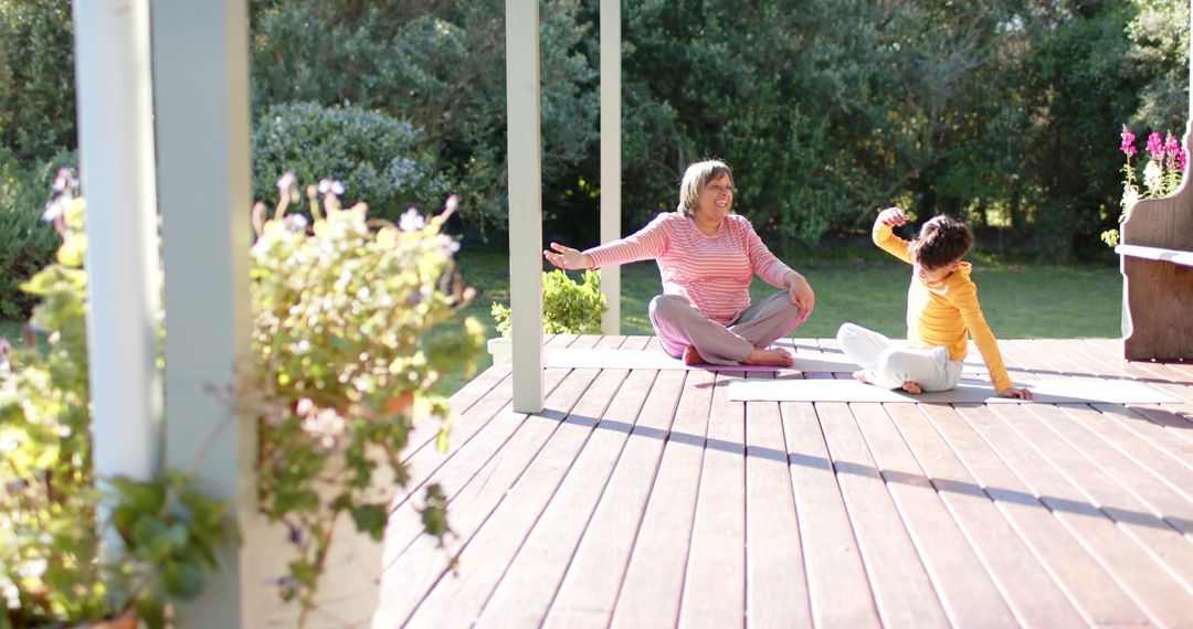 Mother and Daughter Practicing Yoga on Outdoor Wooden Deck - Free Images, Stock Photos and Pictures on Pikwizard.com