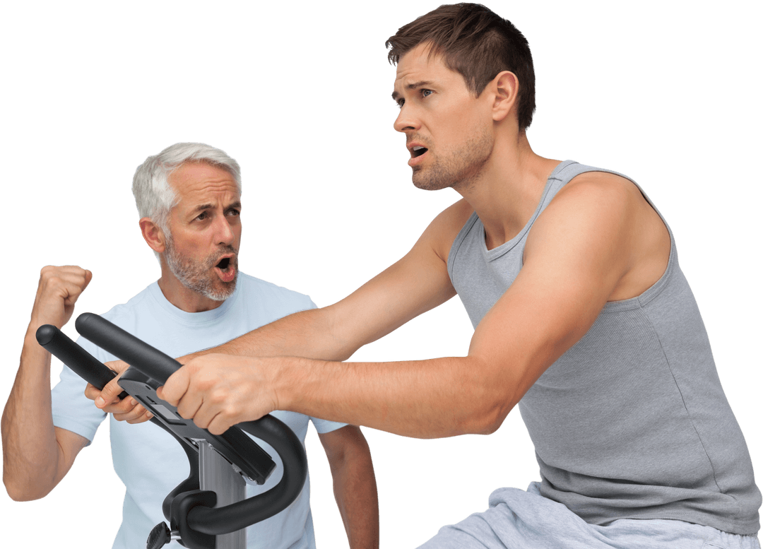 Determined Man Training on Exercise Bike with Enthusiastic Coach
