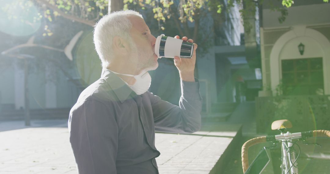 Senior Man Drinking Coffee Outdoors in Morning Sunshine with Bicycle - Free Images, Stock Photos and Pictures on Pikwizard.com