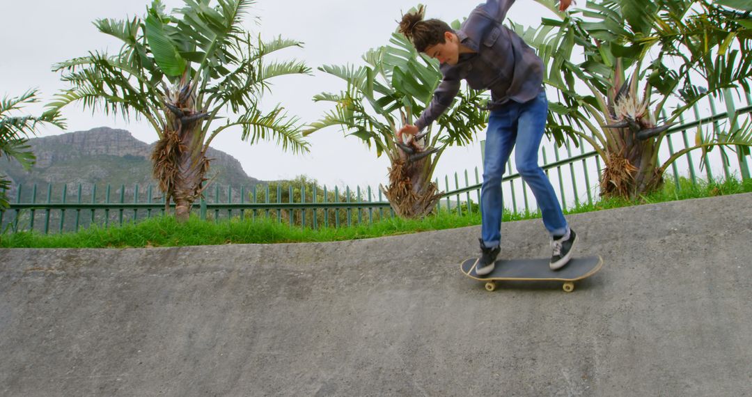 Young Man Skateboarding at Outdoor Skatepark - Free Images, Stock Photos and Pictures on Pikwizard.com