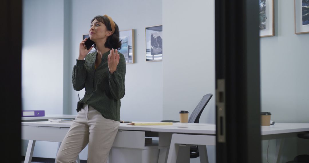 Businesswoman Talking on Phone in Office - Free Images, Stock Photos and Pictures on Pikwizard.com