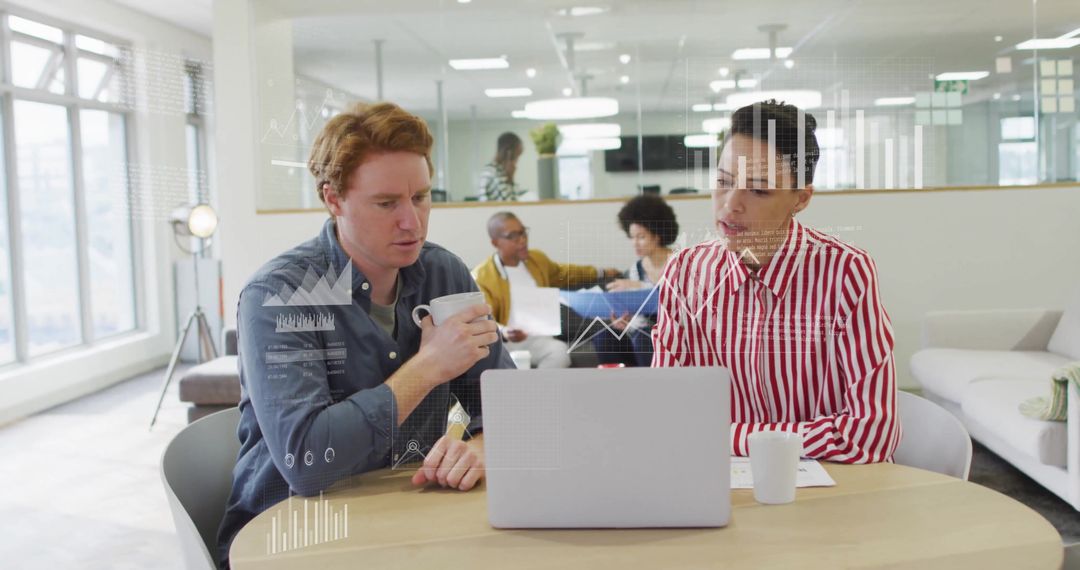 Colleagues Analyzing Data and Reports in Modern Office