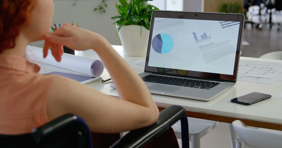 Woman Analyzing Marketing Charts on Laptop in Office - Free Images, Stock Photos and Pictures on Pikwizard.com