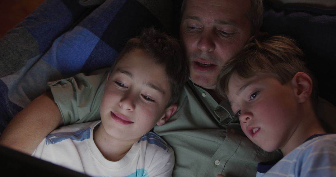 Father Reading Bedtime Story to Sons on Tablet - Free Images, Stock Photos and Pictures on Pikwizard.com