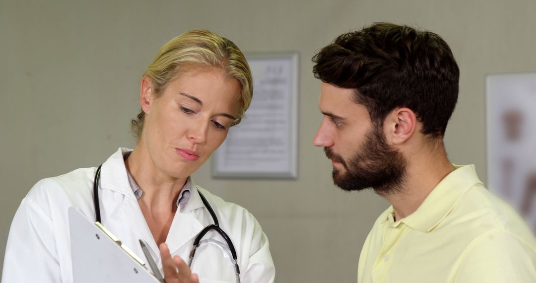 Female doctor consulting with male patient analyzing medical documents - Free Images, Stock Photos and Pictures on Pikwizard.com