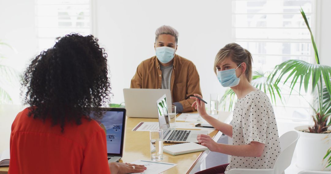 Coworkers in Office Meeting with Masks During Pandemic - Free Images, Stock Photos and Pictures on Pikwizard.com