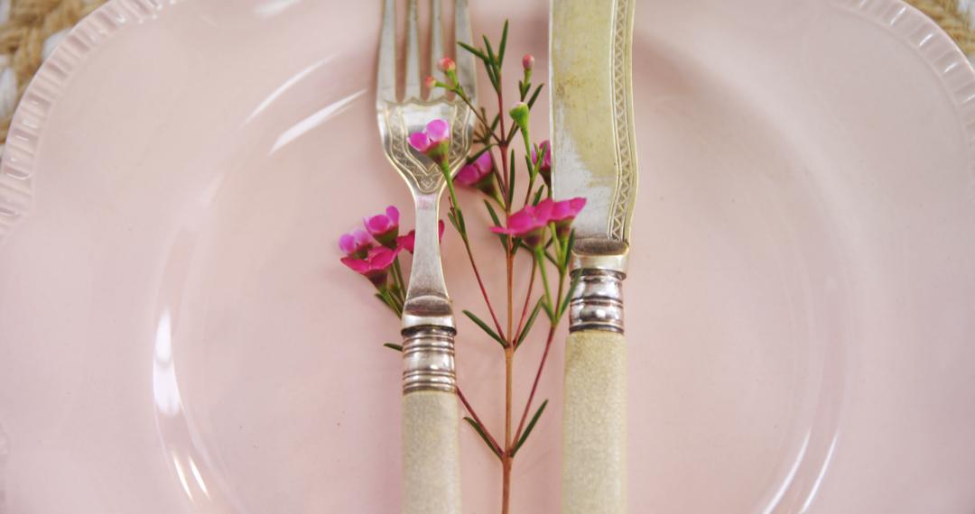 Elegant Table Setting with Fork and Knife on Pink Plate with Flowers - Free Images, Stock Photos and Pictures on Pikwizard.com