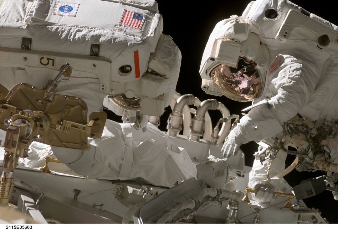 Astronauts Connect Power Cables During 2006 Spacewalk - Free Images, Stock Photos and Pictures on Pikwizard.com