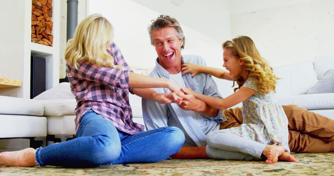 Happy Father Playing with Daughters on Living Room Floor - Free Images, Stock Photos and Pictures on Pikwizard.com