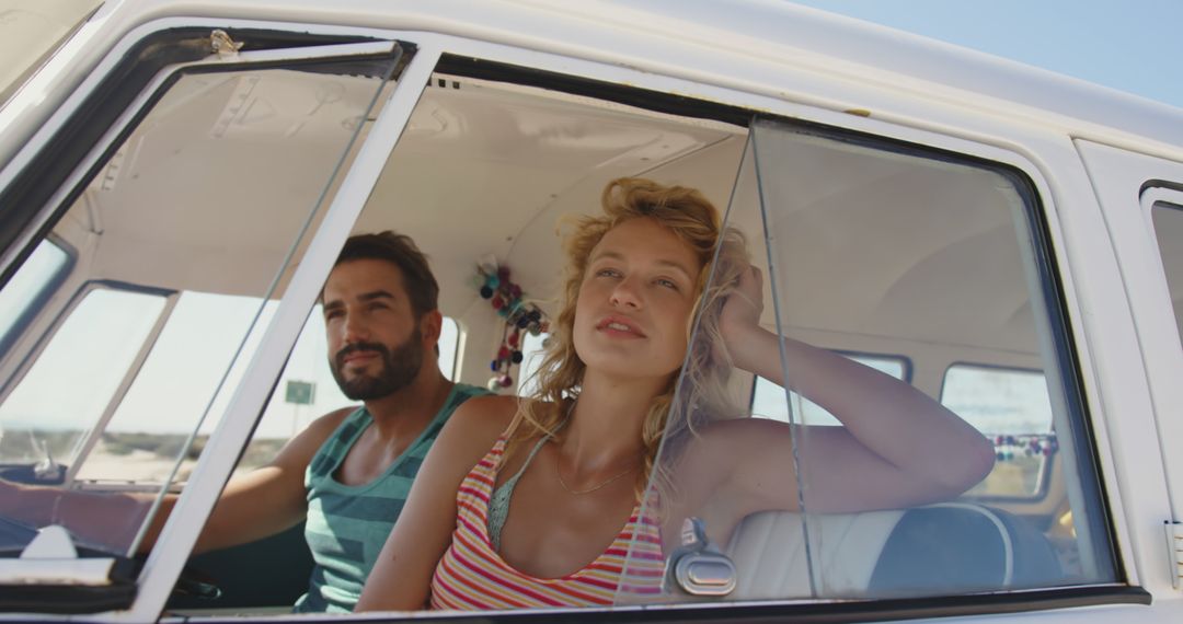 Couple Relaxing in Campervan by Beach