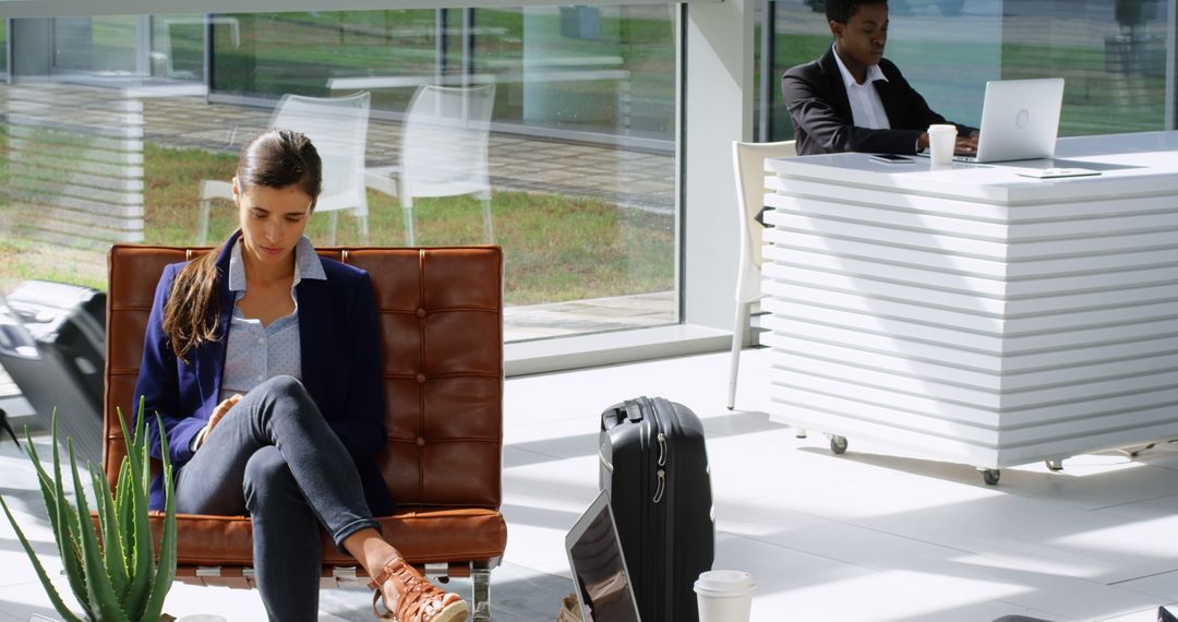 Business Professionals in Modern Lobby with Technology Devices