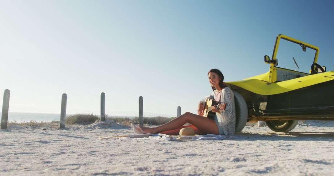 Young Woman Playing Guitar on Beach Near Yellow Car - Free Images, Stock Photos and Pictures on Pikwizard.com