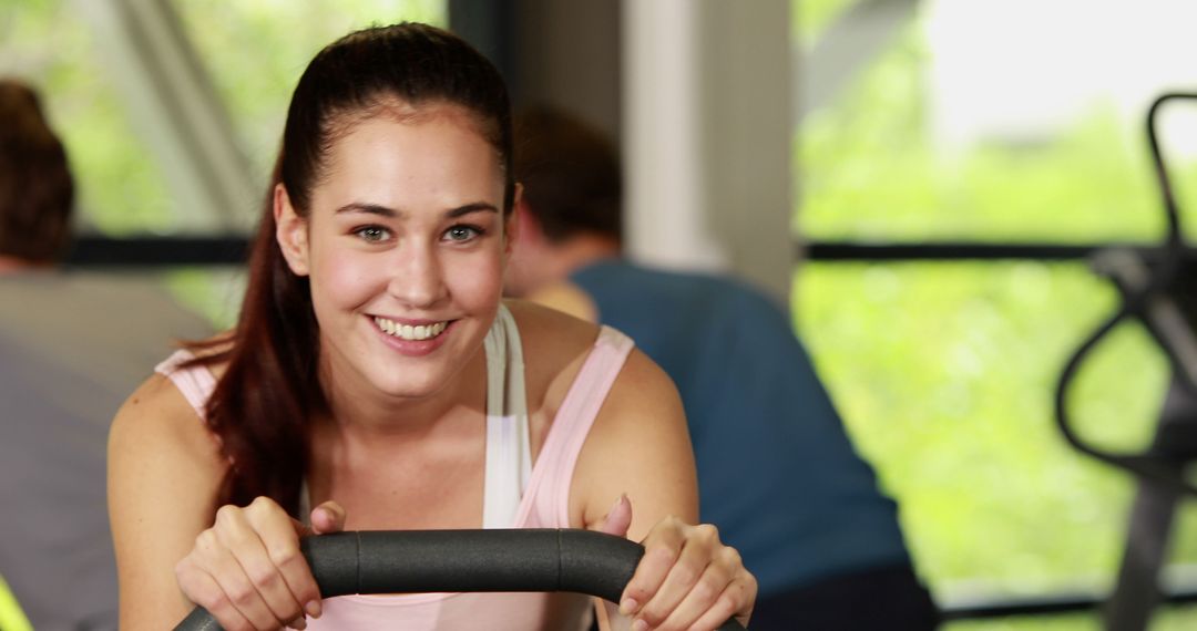 Happy Woman Exercising on Stationary Bike at Gym - Free Images, Stock Photos and Pictures on Pikwizard.com