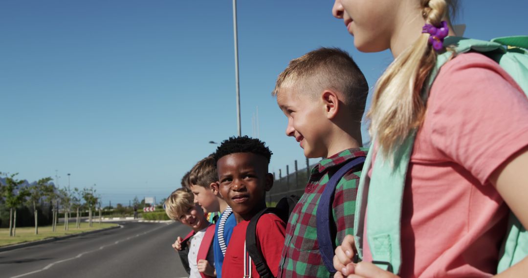 Diverse Schoolchildren Smiling Happily at Crosswalk on Sunny Morning