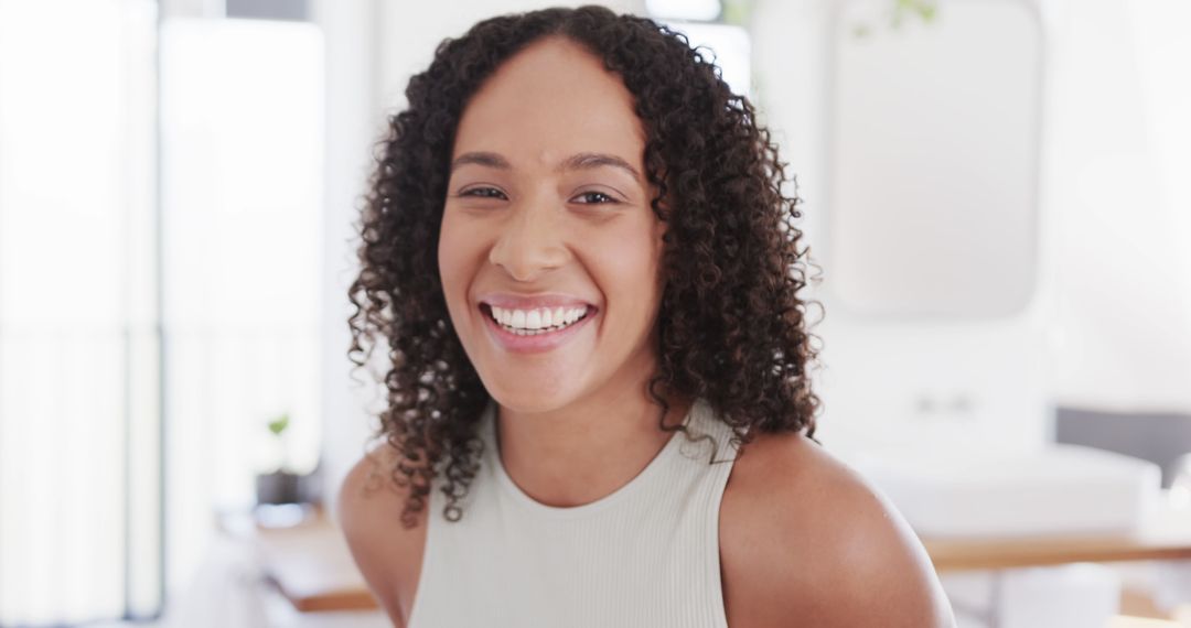 Cheerful Biracial Woman Enjoying Sunny Bathroom Moment