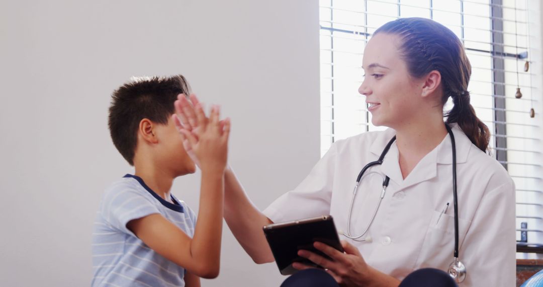 Pediatrician Giving High Five to Child During Medical Visit - Free Images, Stock Photos and Pictures on Pikwizard.com