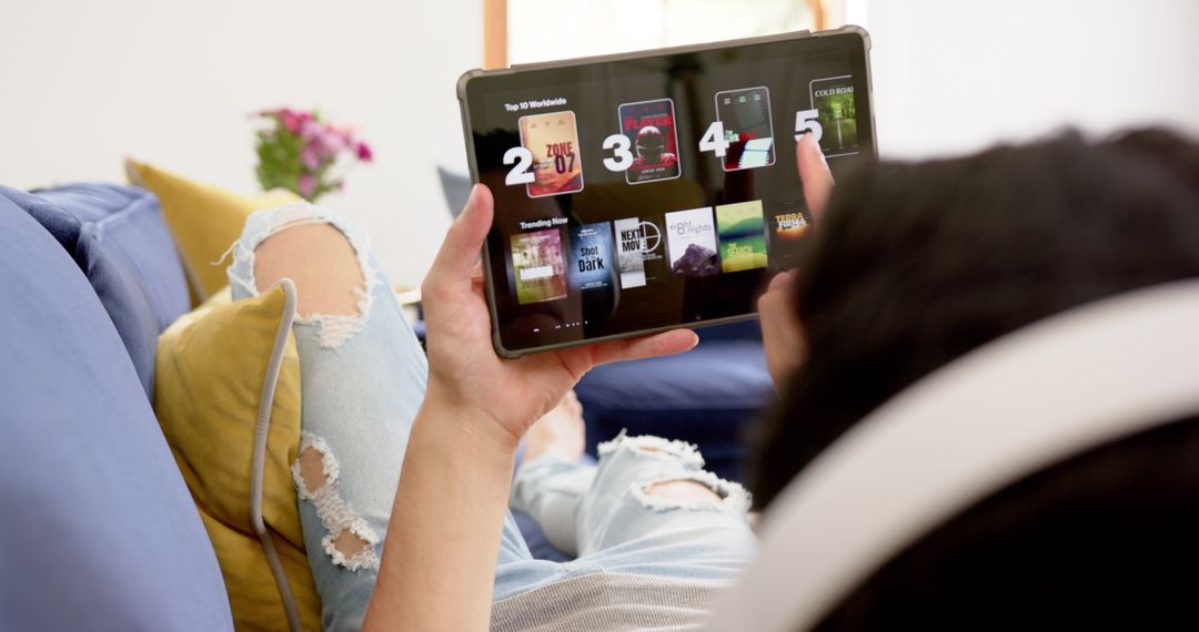 Man Relaxing with Tablet and Headphones in Living Room