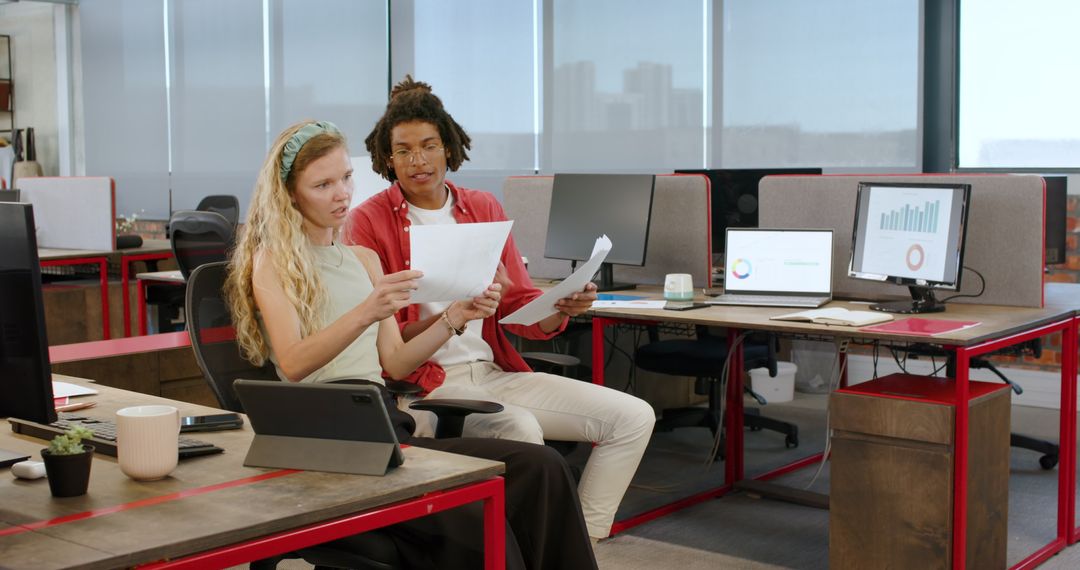 Colleagues Discussing Project with Technology in Modern Office