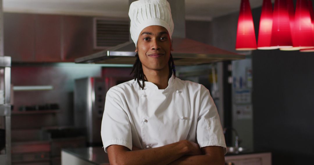 Biracial male chef standing in kitchen looking at camera and smiling - Free Images, Stock Photos and Pictures on Pikwizard.com