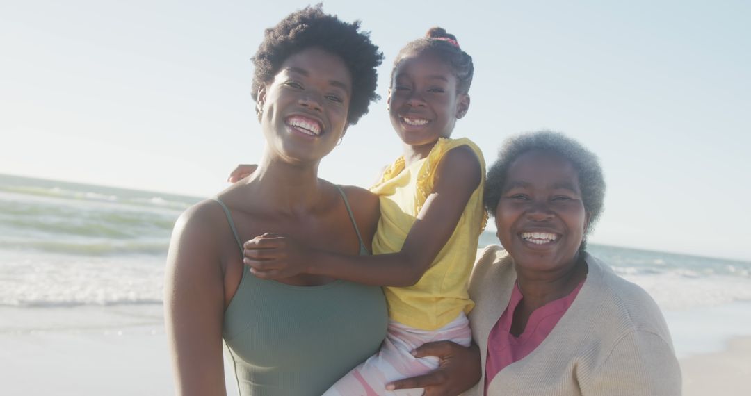 Three Generations Smiling by the Ocean on a Sunny Day