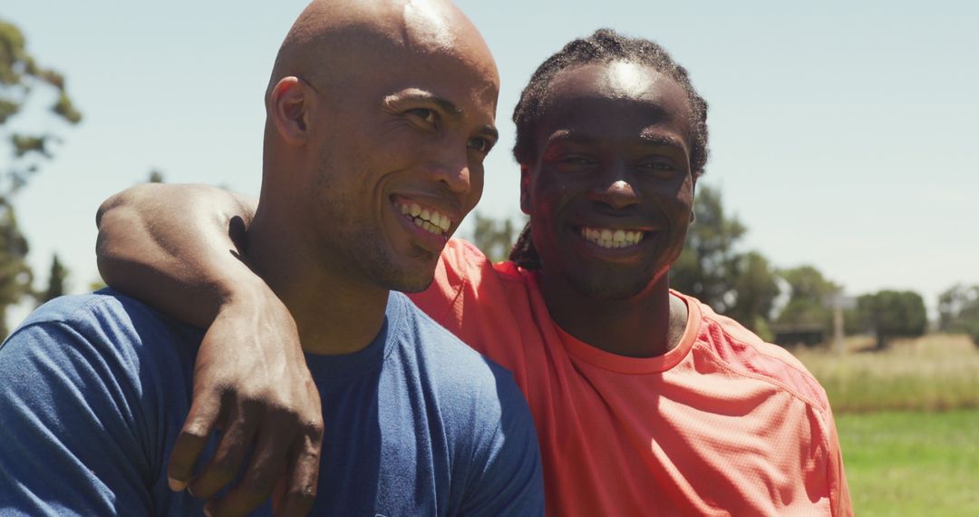 Two Active Men Smiling Together After Outdoor Training Session