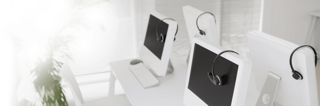 Transparent Office Computers with Headsets on Desk