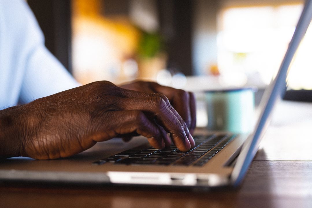 Senior African American Man Typing on Laptop in Log Cabin - Free Images, Stock Photos and Pictures on Pikwizard.com