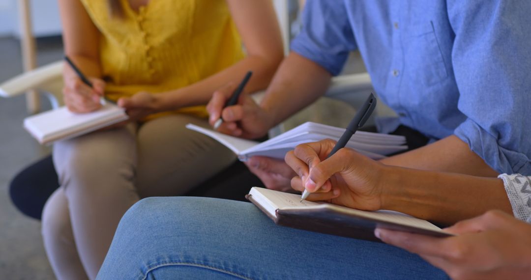 Colleagues Collaborating and Note-taking in Modern Office