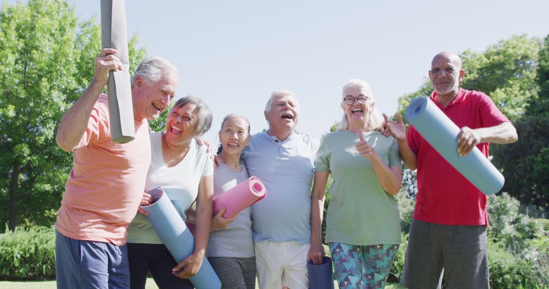 Happy Multiracial Group of Seniors Laughing and Holding Yoga Mats Outdoors - Free Images, Stock Photos and Pictures on Pikwizard.com