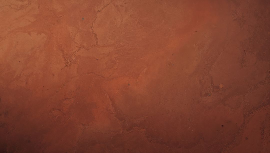 Displaying rusty cracked earth texture with winding fissures and warm terracotta tones