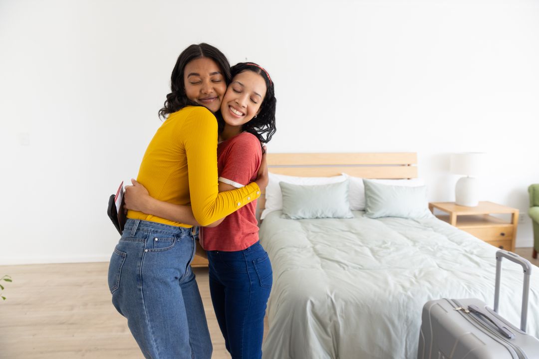 Mother and Daughter Embracing in Modern Bedroom Setting