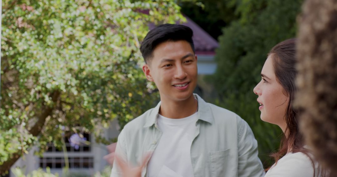 Smiling Friends Conversing in Sunlit Garden